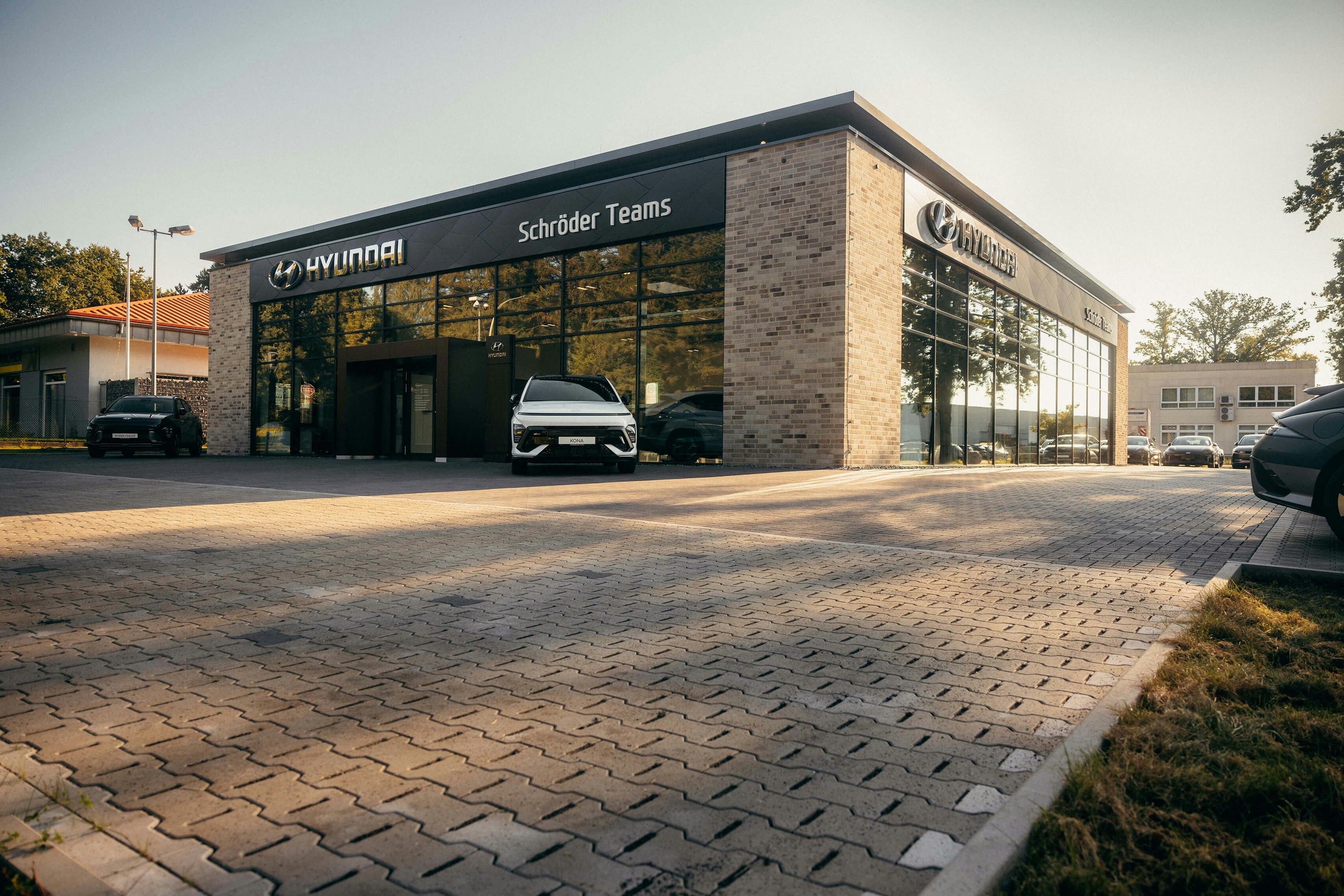 Hyundai Angebote bei Schröder Teams – aktuelle Modelle entdecken Außenansicht des Hyundai Autohauses Schröder Teams mit geparktem Hyundai Fahrzeug und attraktiven Angeboten